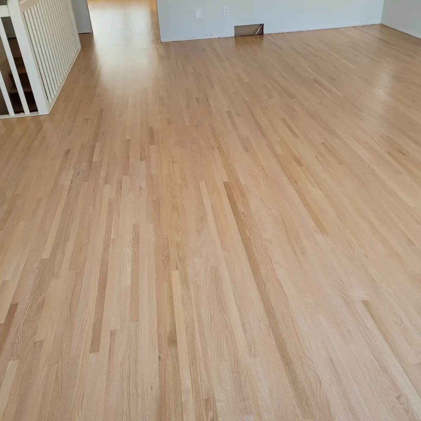 Finished red oak floor in an empty living room